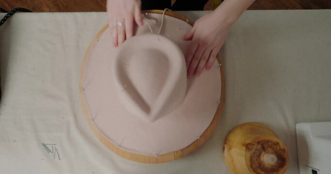 Hat-maker takes care of shape for handmade headwear