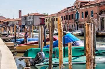 Fototapeta na wymiar Murano, Italy - July 7, 2022: Scenery along the canals in Murano Italy 