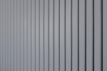 Gray vertical wooden panels close-up on the wall