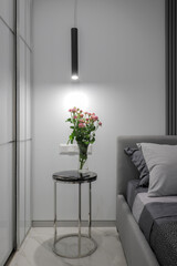 Flowers in the vase on a bedside table