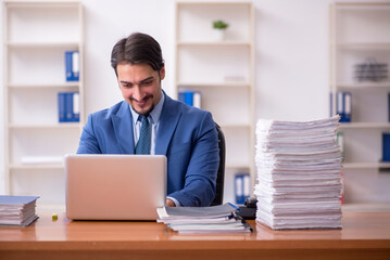 Young businessman employee and too much work in the office