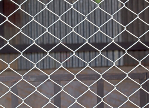 Blurred image behind white steel mesh nature blur background