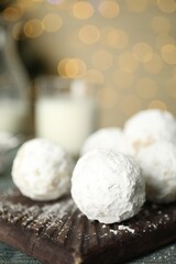 Fototapeta na wymiar Tasty Christmas snowball cookies on table, closeup. Space for text