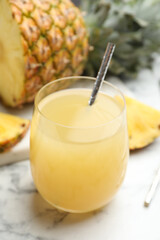 Delicious fresh pineapple juice on white marble table