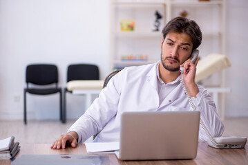 Young male doctor in telemedicine concept
