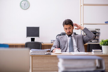Young male employee working in the office
