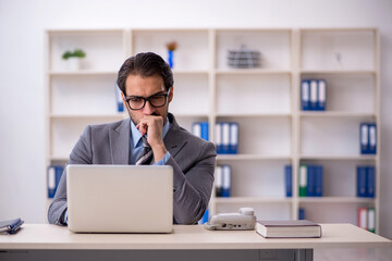 Young male employee working in the office