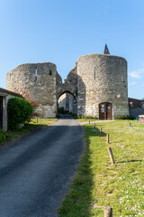 Fototapeta na wymiar View of Yevre le Chatel medieval fortified gate with two round towers protecting the strategically important town
