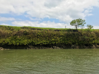 Landscape view of river and highlands isolated with blue sky