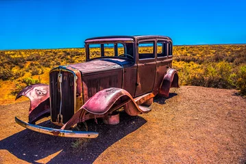 Gordijnen Three quarter view of 1930's Vintage Auto on Route 66 at Painted Desert NP near Holbrook Arizona © Claire