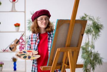 Young girl enjoying painting at home