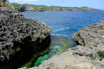 Fototapeta na wymiar Indonesia Penida Island - Angel Billabong - natural pool framed rock cliffs