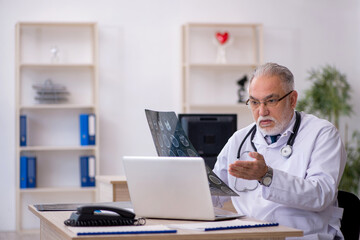 Fototapeta premium Old male doctor radiologist working in the clinic