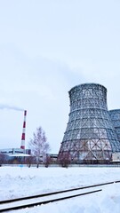 Gas combined heat and power plant with huge pipes, smoke, steam,