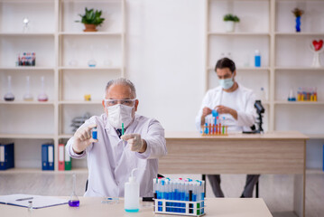 Two male chemist working at the lab