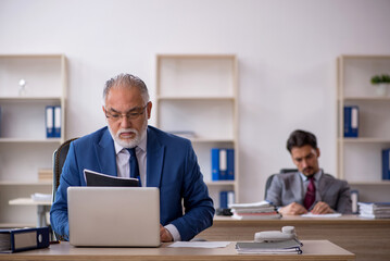Two male colleagues working in the office