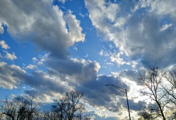 Fototapeta na wymiar Bright Sunlit Cloudscape Over April Street