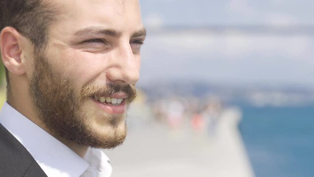 Smiling businessman.
Smiling business man standing by the Sea in the city against the sea.
