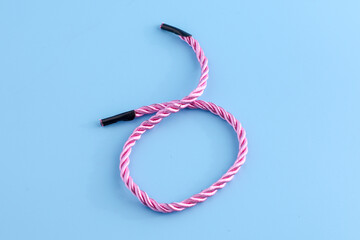 Blue background picture with a pastel pink rope