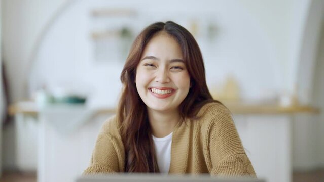 Portrait smiling asian young woman looking to camera. Facial expression happy
