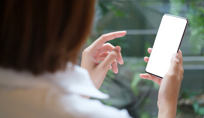 Woman holding smart phone with white empty screen.