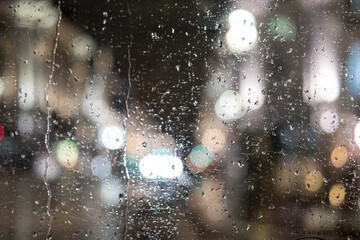 Rain drops on the glass with blurred background of the road - obrazy, fototapety, plakaty