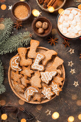  A plate of traditional homemade Christmas gingerbread cookies decorated with icing sugar vertical...