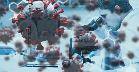 Covid-19 cells against male scientist using a microscope