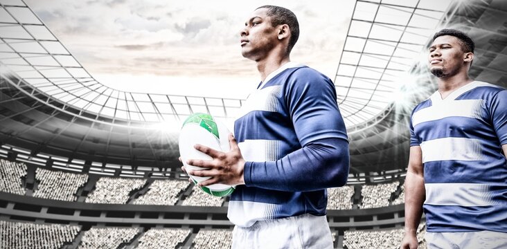 Digital composite image of two rugby players holding ball in sports stadium