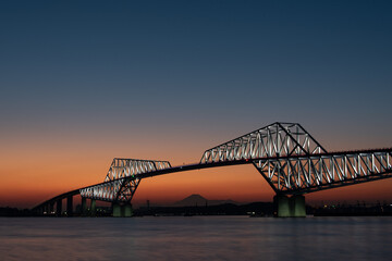 Fototapeta na wymiar Bridge at sunset with Mount Fuji silhouette