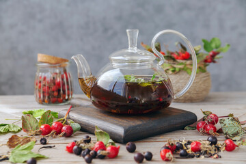 Hot tea with rose hips and herbs in a glass bowl. Drink containing vitamin C and antioxidants.