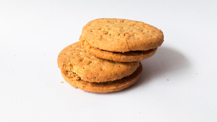 BISCUITS - Delicious wheat round biscuits with a few crumbs isolated on white