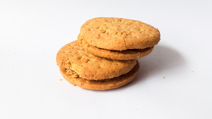 BISCUITS - Delicious wheat round biscuits with a few crumbs isolated on white