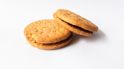 BISCUITS - Delicious wheat round biscuits with a few crumbs isolated on white