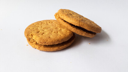 BISCUITS - Delicious wheat round biscuits with a few crumbs isolated on white