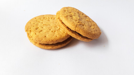 BISCUITS - Delicious wheat round biscuits with a few crumbs isolated on white