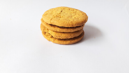 BISCUITS - Delicious wheat round biscuits with a few crumbs isolated on white