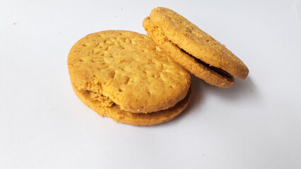 BISCUITS - Delicious wheat round biscuits with a few crumbs isolated on white