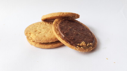 A stack of delicious wheat round biscuits with chocolate filling isolated on white background