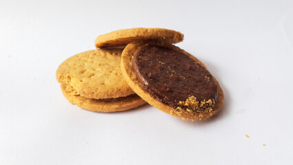 A stack of delicious wheat round biscuits with chocolate filling isolated on white background