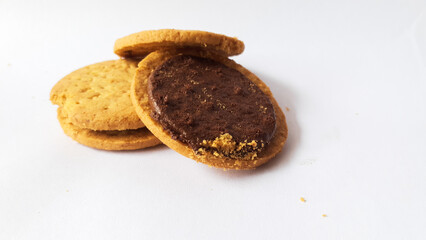 A stack of delicious wheat round biscuits with chocolate filling isolated on white background