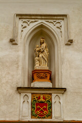 Religious stone statue on façade of building in Old Town Prague, Czech Republic in Bohemia