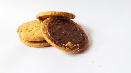 A stack of delicious wheat round biscuits with chocolate filling isolated on white background