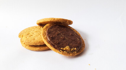 A stack of delicious wheat round biscuits with chocolate filling isolated on white background