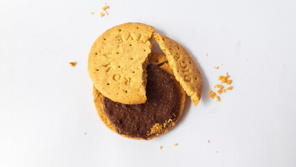 A stack of delicious wheat round biscuits with chocolate filling isolated on white background