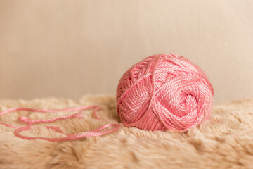 Large ball of threads on a fur rug close-up with space for text. © Евгения Смульская