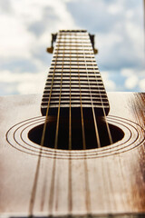 Obraz premium Old guitar with strings, close-up. Acoustic guitar music instrument