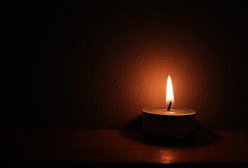 burning candle in the dark