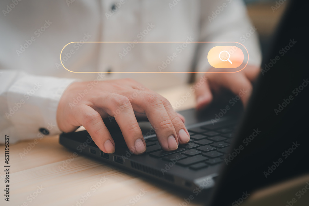 Leinwandbilder Freelance's hand working with computer laptop on desk in home. Searching Browsing Internet Data Information with blank search bar. Search Engine Optimization SEO Networking Concept.