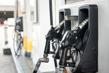 Fototapeta na wymiar Gasoline refuel nozzle head at the petrol station. Transportation equipment object, selective focus.